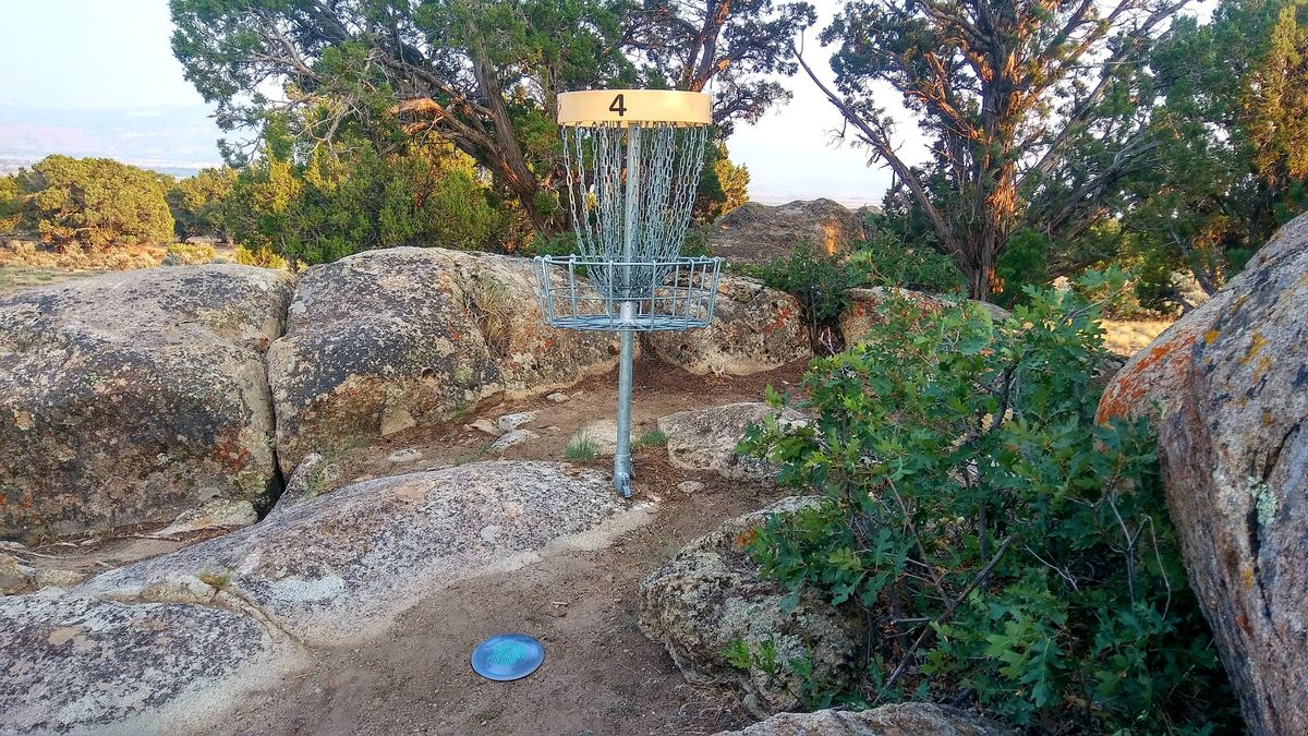 Basket nestled between rocks and juniper trees at Three Peaks
