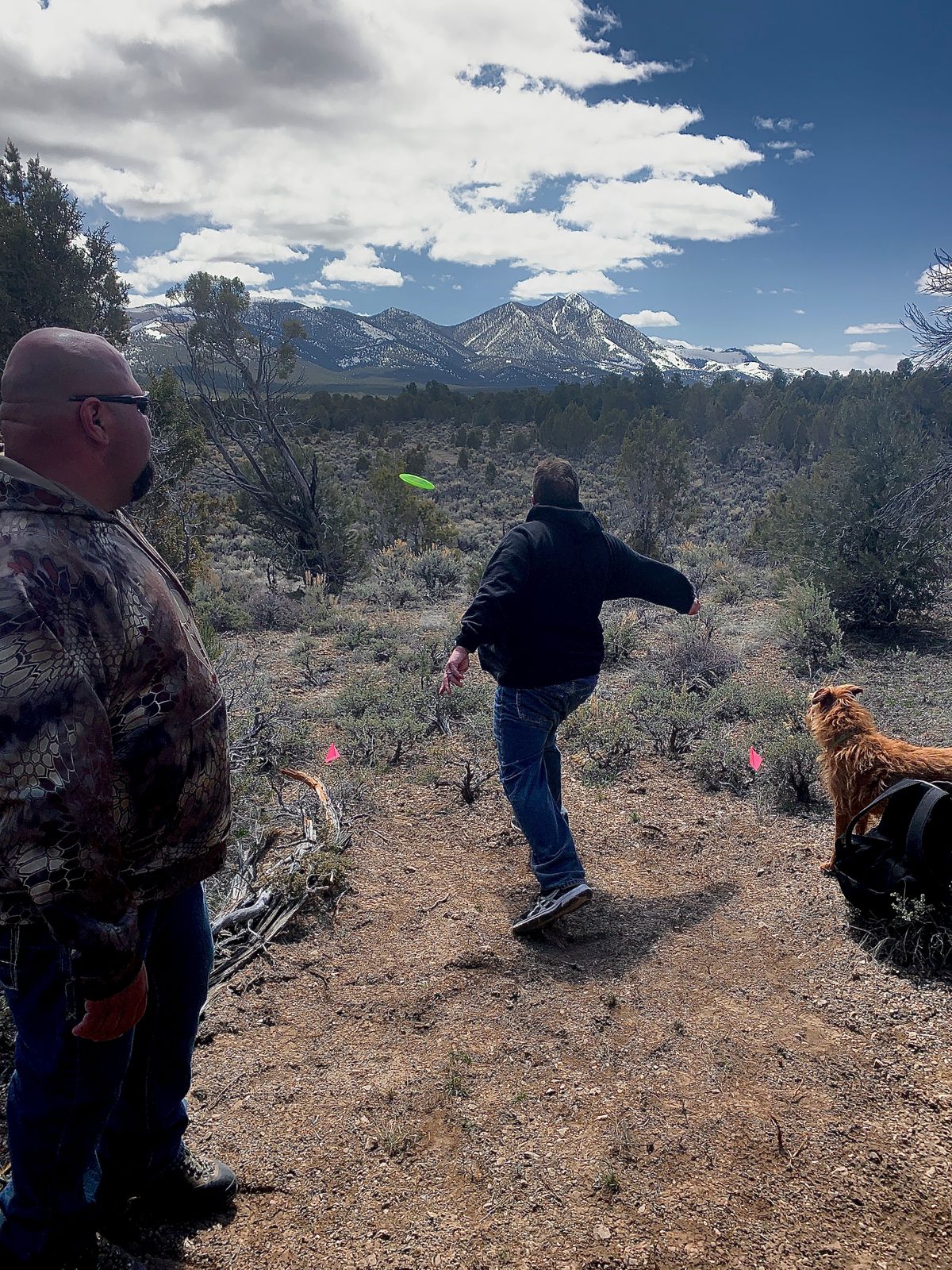 Players throwing with snow-capped mountains in the background at Ward Mountain
